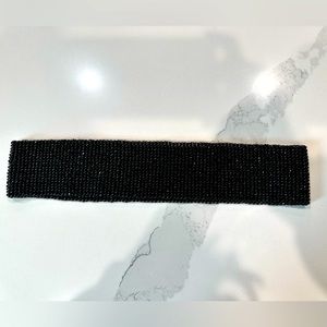 Thick microbeaded belt without buckle/attachment. Stretches to take on/off.